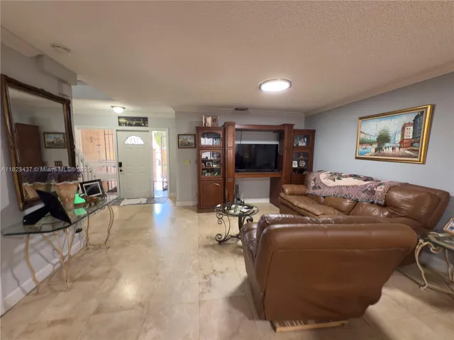 a large kitchen with a table and chairs