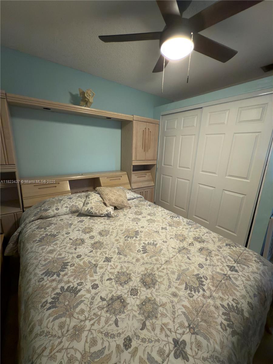 1651 Southwest 120th Avenue Pembroke Pines, FL 33025 - Photo 17 of 34 a bedroom with a bed and a mirror