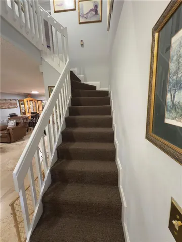 a large bathroom with a granite countertop sink a toilet a mirror and shower
