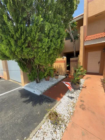 a pathway of a house with a yard