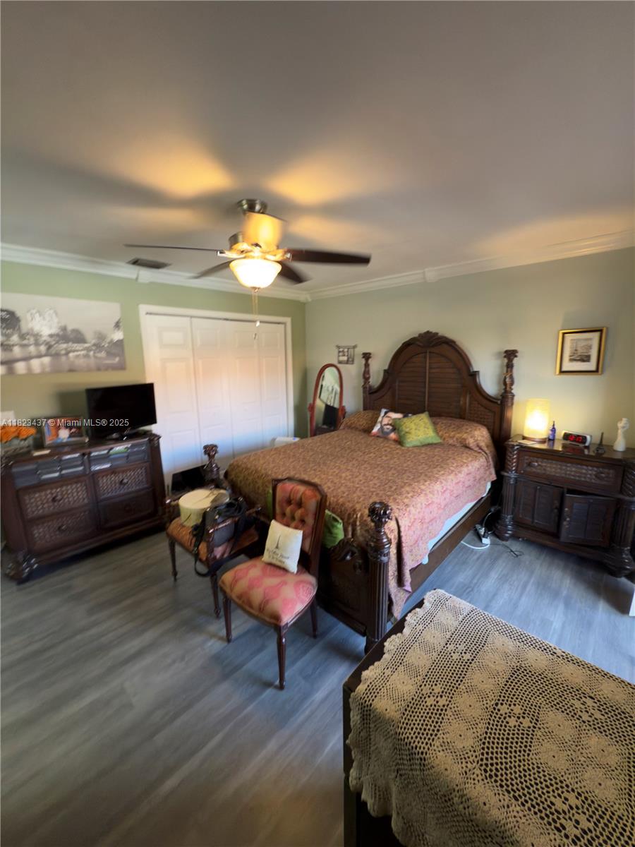 1651 Southwest 120th Avenue Pembroke Pines, FL 33025 - Photo 22 of 34 a bedroom with a bed wooden floor and furniture