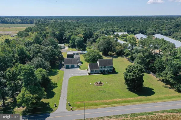 an aerial view of a house with a yard and lake view