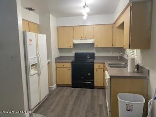 1055 Marlin Drive Rockledge, FL 32955 - Photo 5 of 14 a kitchen with a refrigerator sink and stove