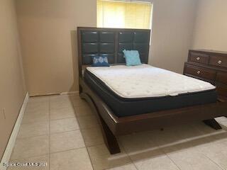 1055 Marlin Drive Rockledge, FL 32955 - Photo 9 of 14 a bed sitting in a bathroom next to a window