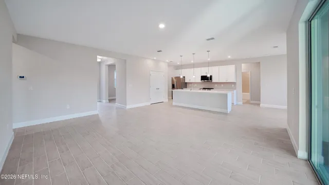 a large white kitchen with white cabinets and white appliances