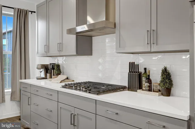 a large kitchen with kitchen island a large counter top space a sink stainless steel appliances and cabinets