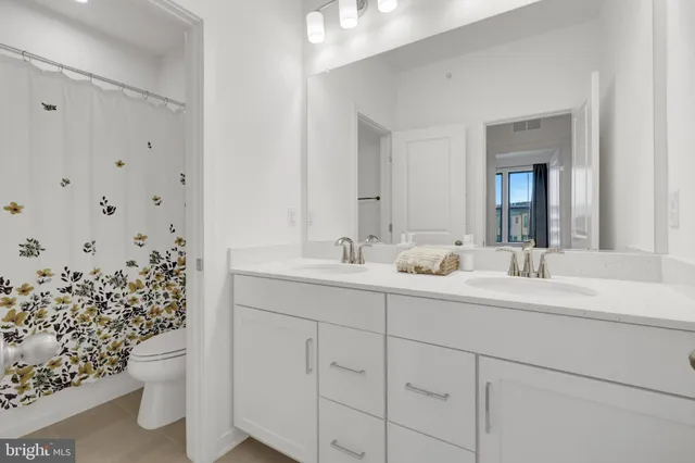 a front view of a building with parking space and a street view