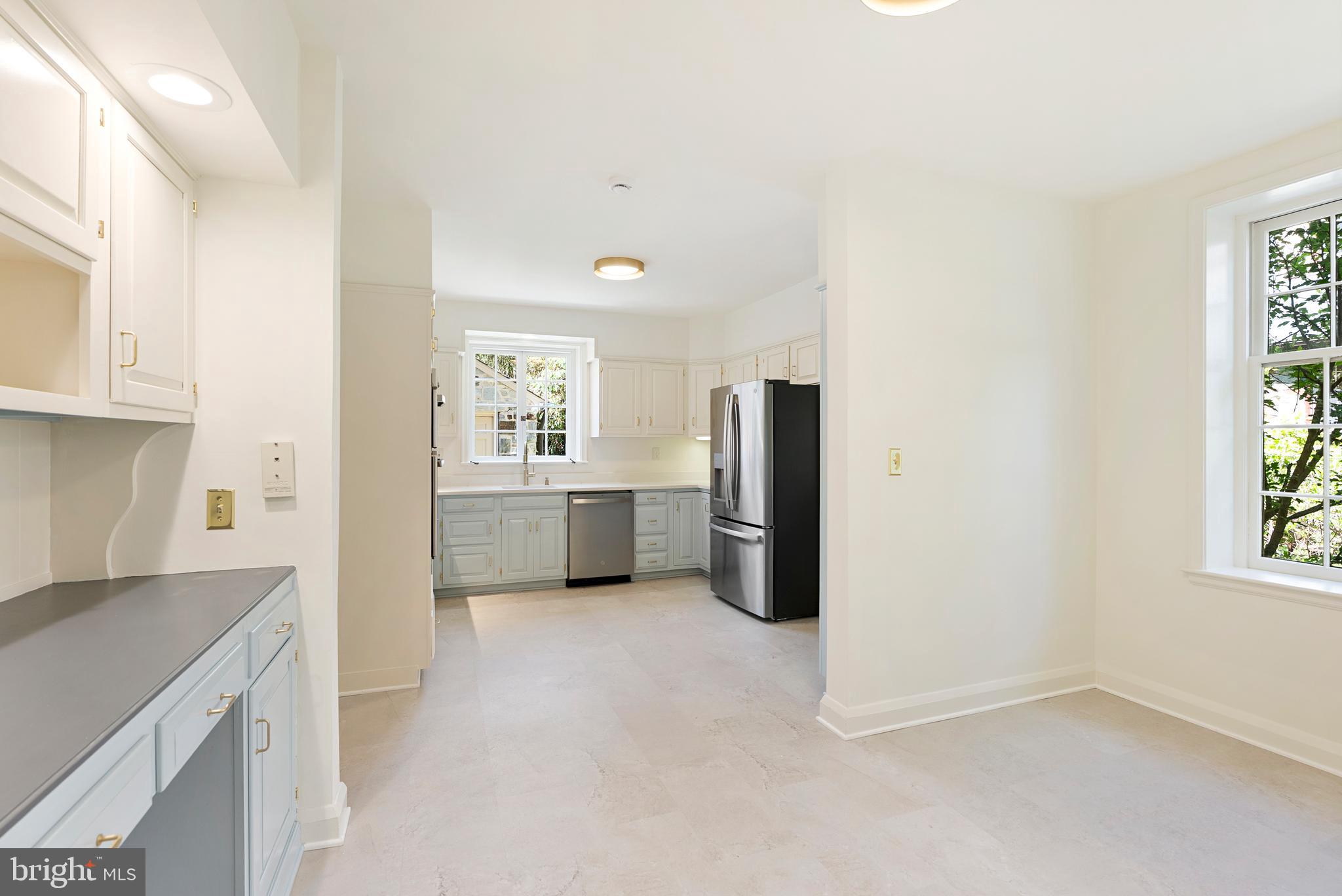602 Stoneleigh Road Baltimore, MD 21212 - Photo 12 of 31 a kitchen with refrigerator cabinets and wooden floor