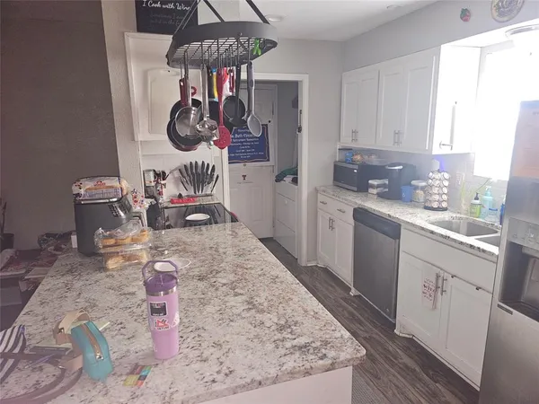 a kitchen with a sink a stove and cabinets