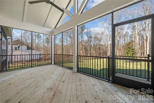 a view of a porch with wooden floor and iron stairs