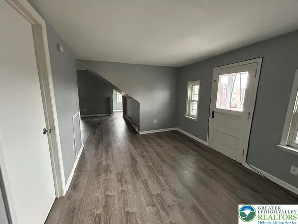 a view of hallway with wooden floor