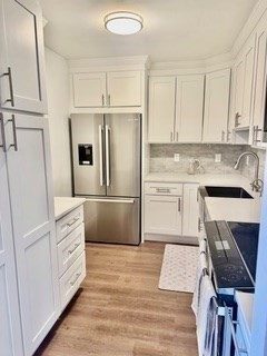 41 Park Brookline Ma, Unit 404 Brookline, MA 02446 - Photo 2 of 24 a kitchen with white cabinets and white appliances