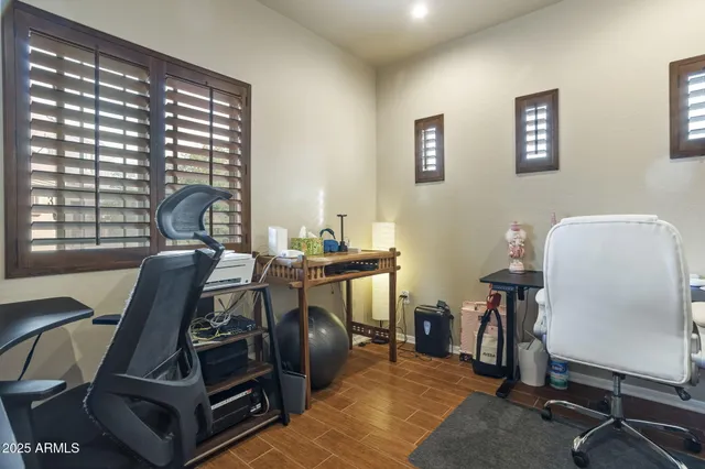 a view of a workspace with furniture and a window
