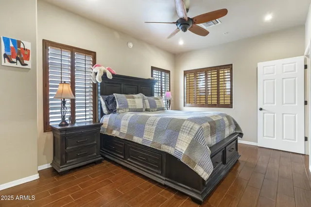 a bed sitting in a bedroom next to a window