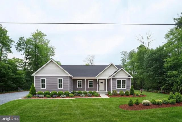 a front view of a house with a garden and plants
