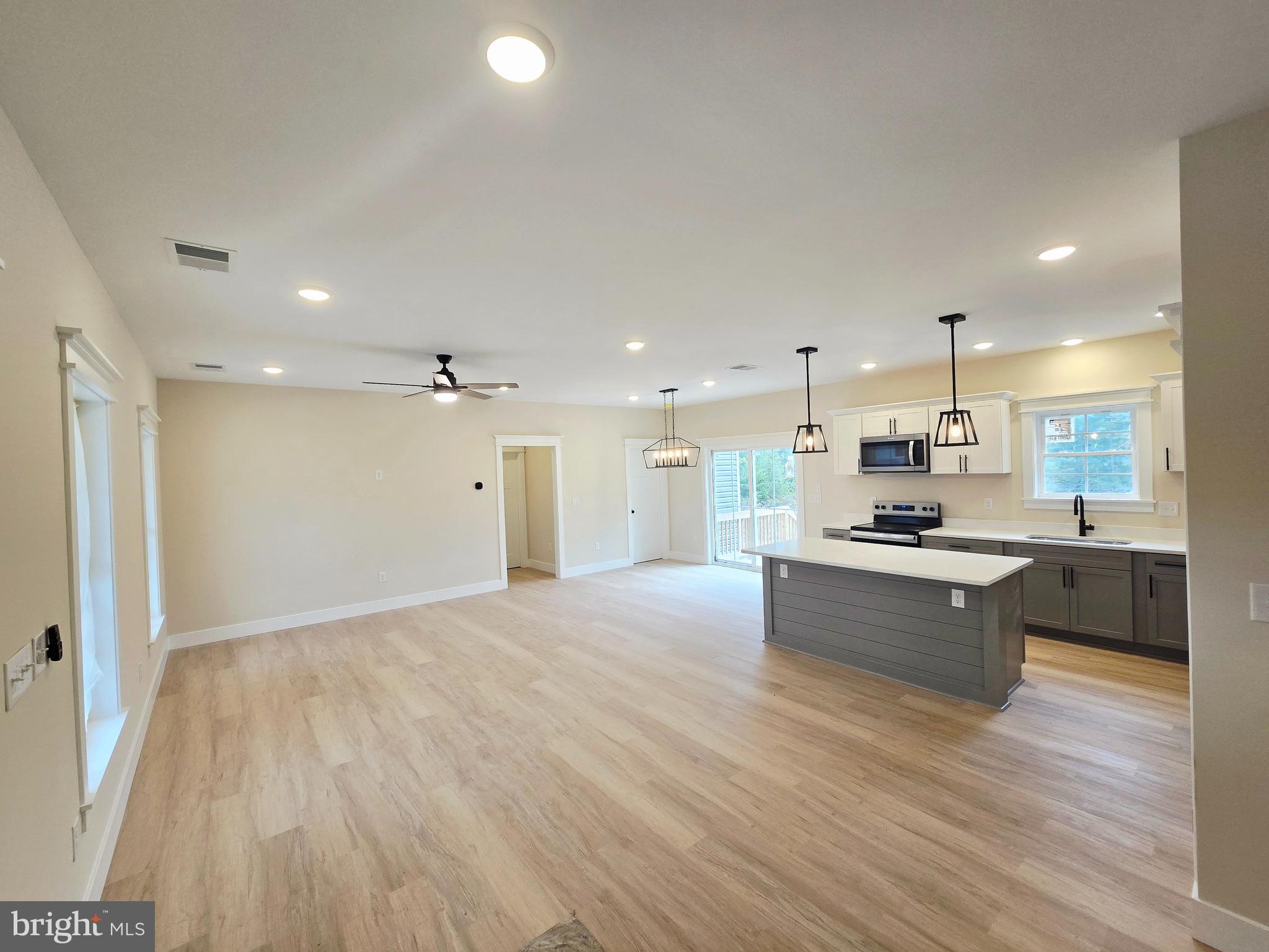 26707 Shortly Road Georgetown, DE 19947 - Photo 13 of 35 a large kitchen with kitchen island a sink stainless steel appliances and cabinets