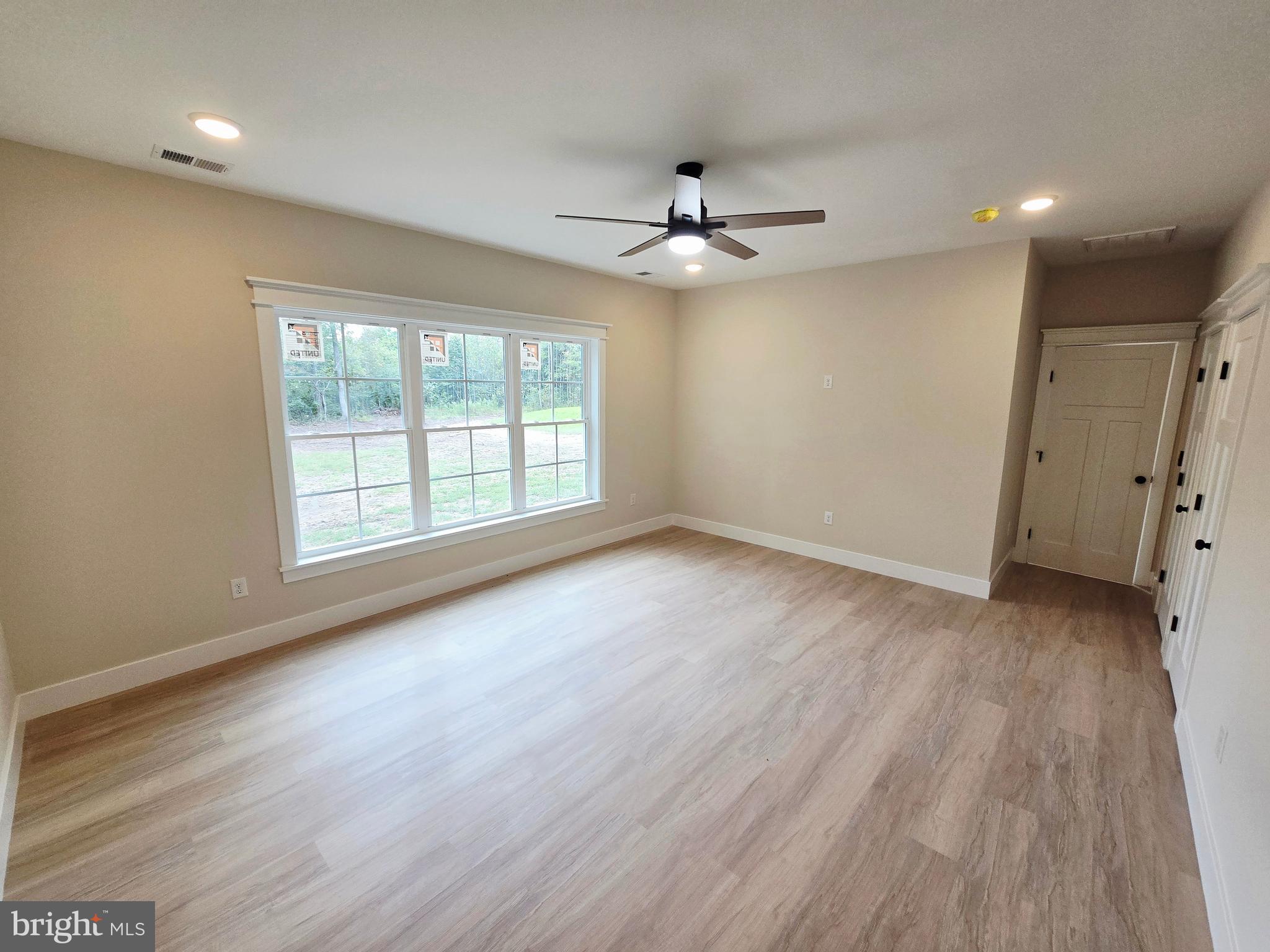 26707 Shortly Road Georgetown, DE 19947 - Photo 14 of 35 wooden floor in an empty room with a window