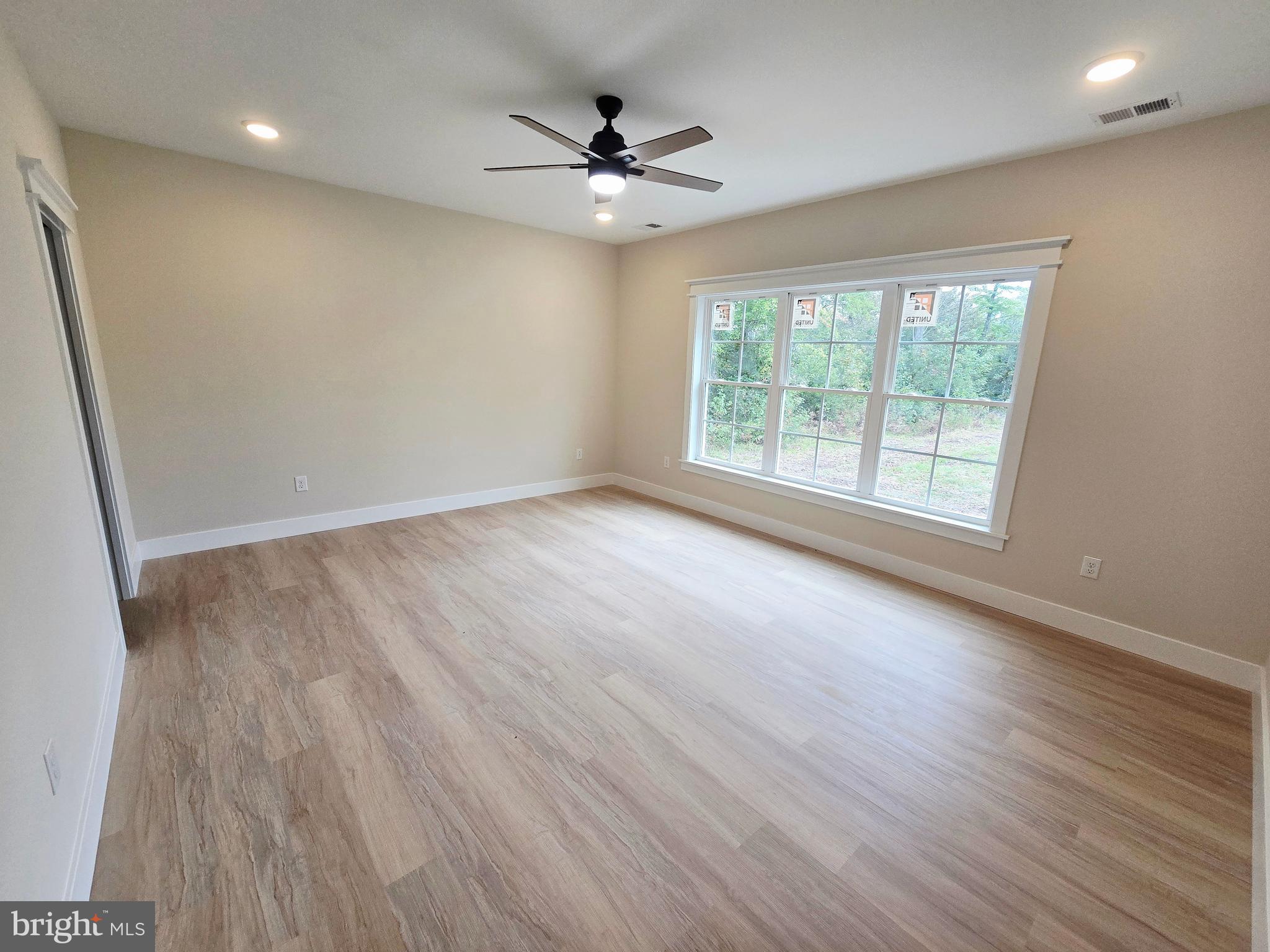 26707 Shortly Road Georgetown, DE 19947 - Photo 15 of 35 an empty room with wooden floor and windows