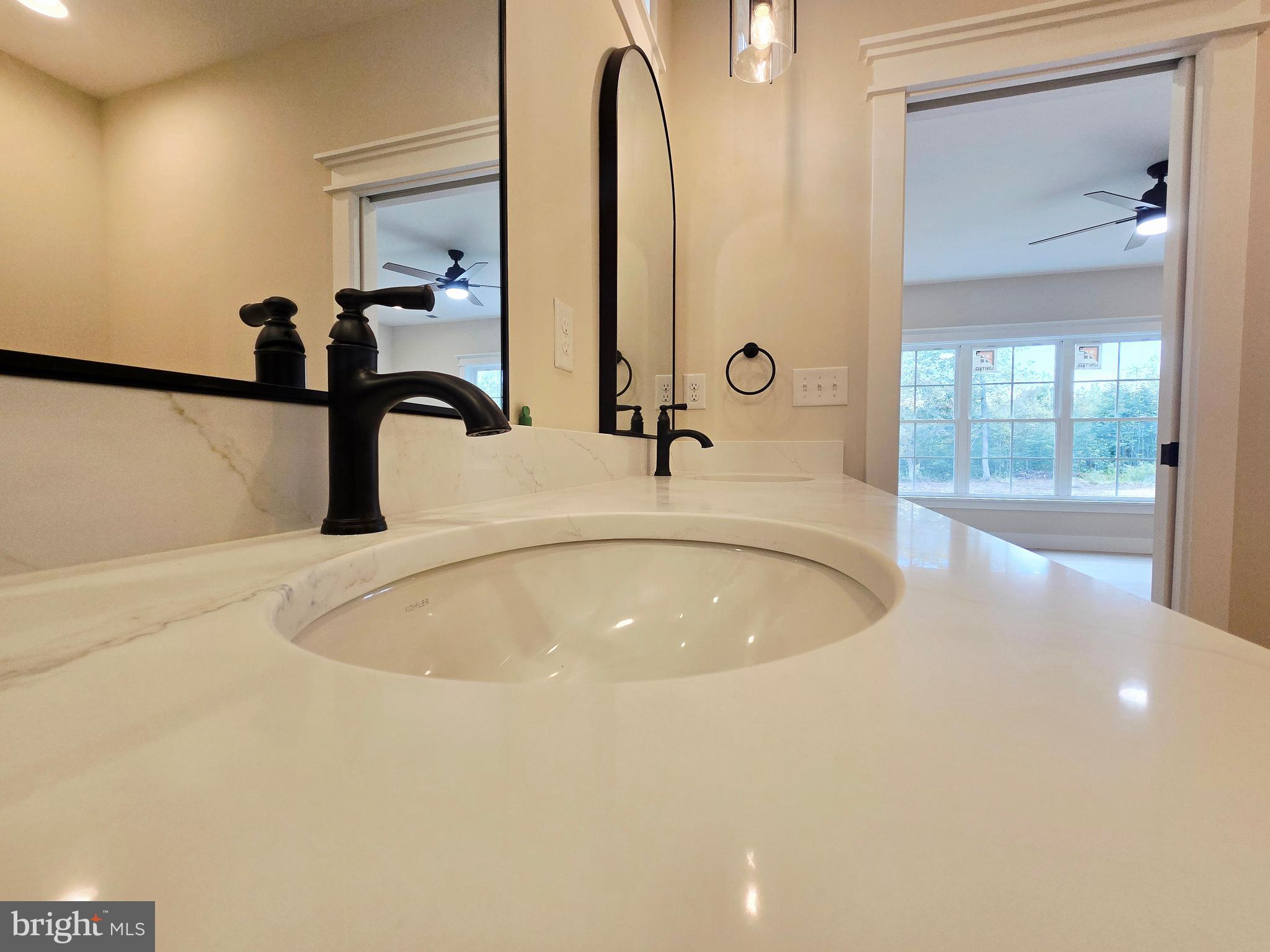 26707 Shortly Road Georgetown, DE 19947 - Photo 21 of 35 a bathroom with a tub sink and mirror