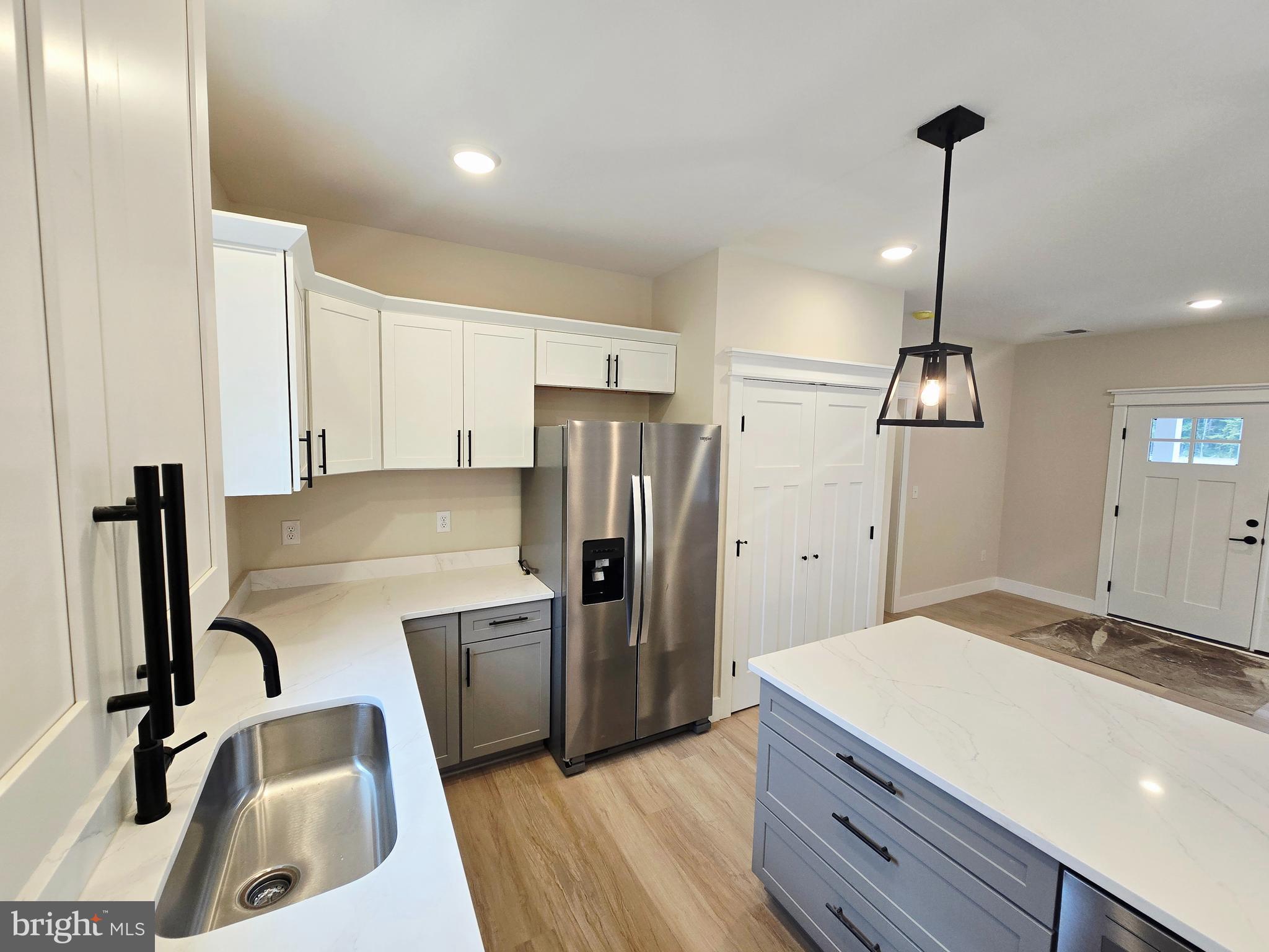 26707 Shortly Road Georgetown, DE 19947 - Photo 9 of 35 a kitchen with refrigerator cabinets and wooden floor