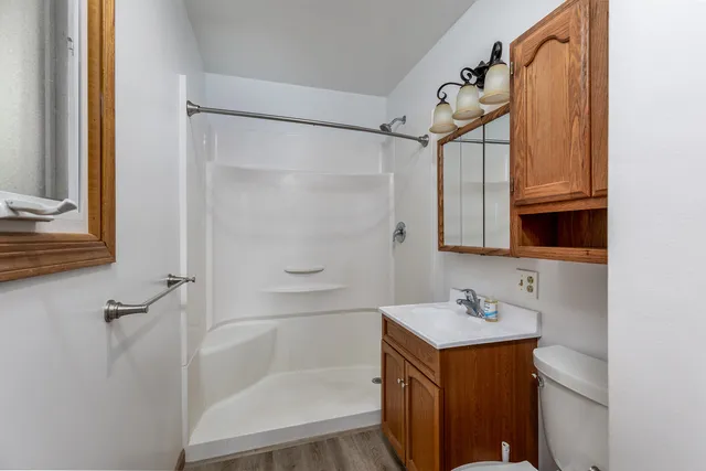 a bathroom with a shower sink and mirror