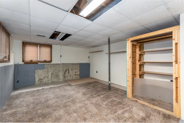 a view of an empty room with a cabinet