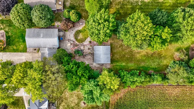 an aerial view of a house with a yard and garden