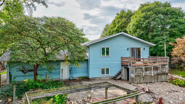 a view of house with backyard outdoor seating and green space