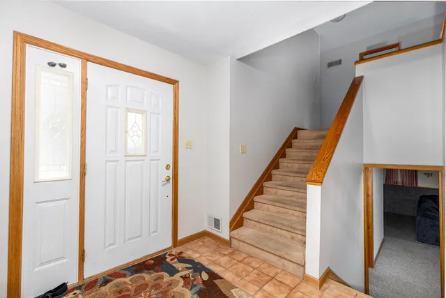 a view of a hallway with closet and wooden floor