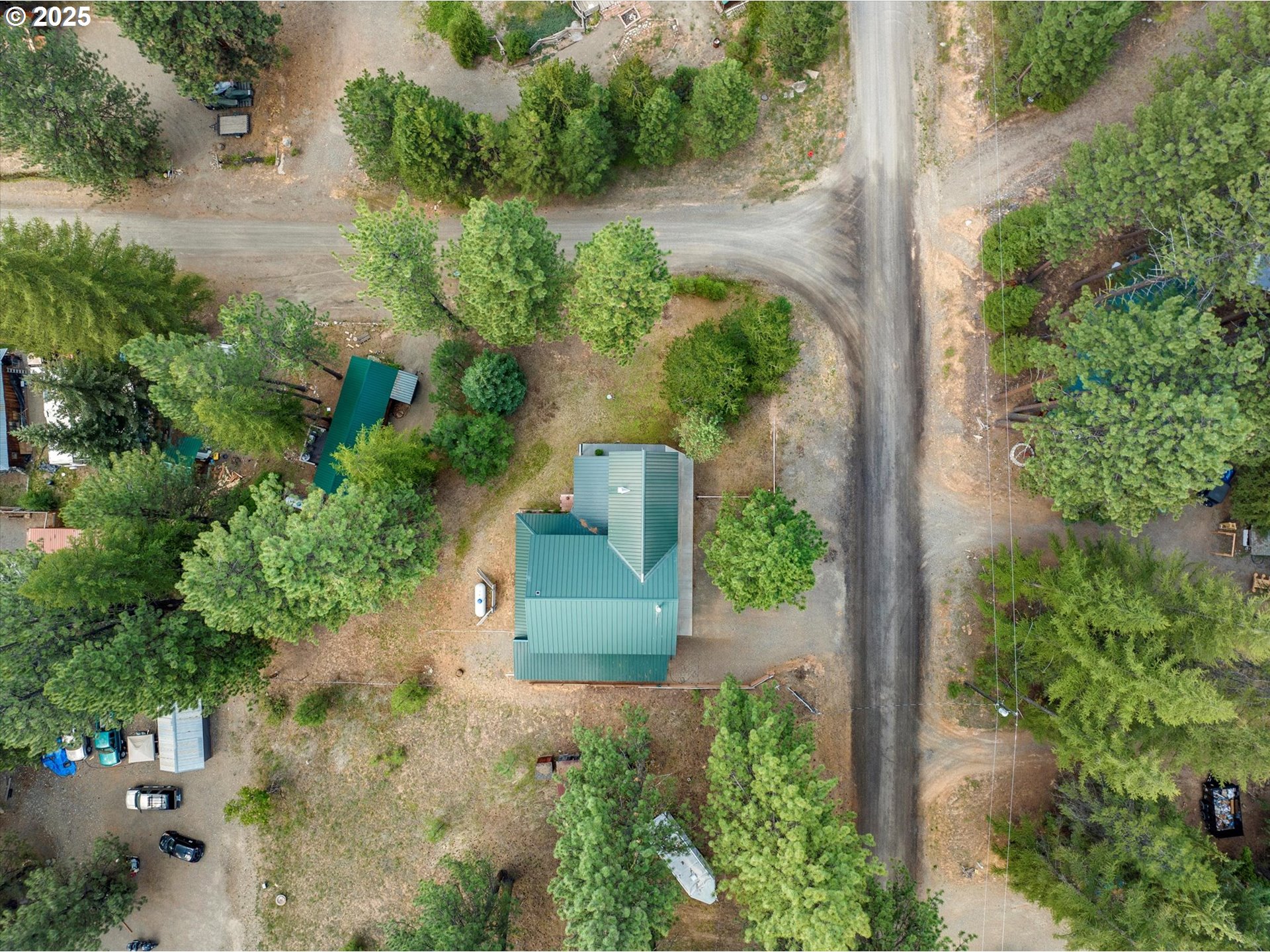 395 Bonanza Street Sumpter, OR 97877 - Photo 15 of 39 an aerial view of a house with a yard and trees all around