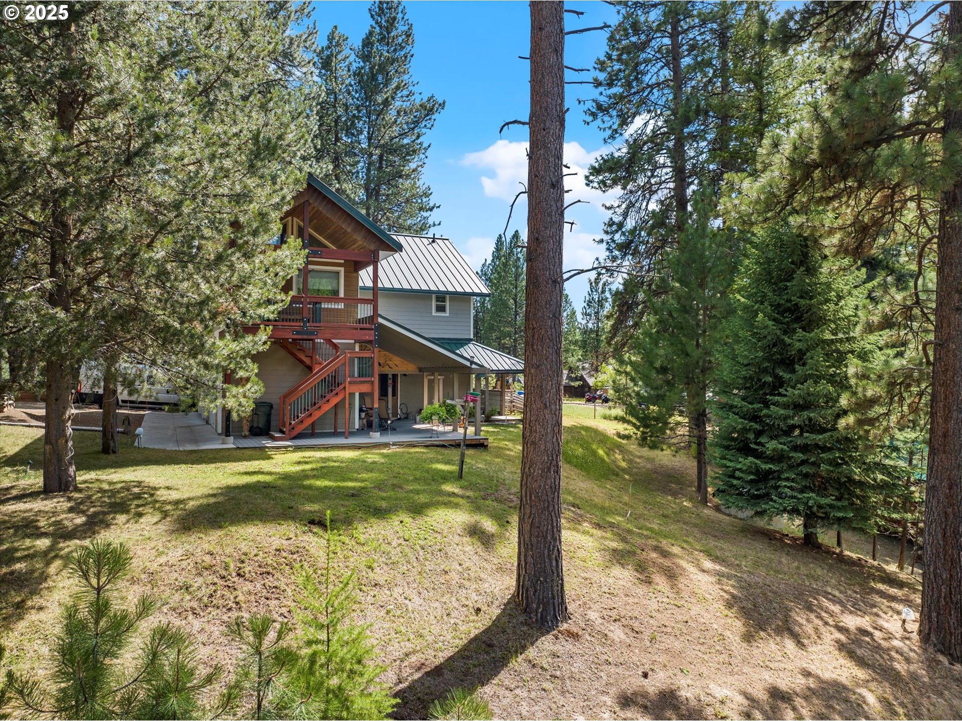 395 Bonanza Street Sumpter, OR 97877 - Photo 10 of 39 a view of a house with pool yard and large trees