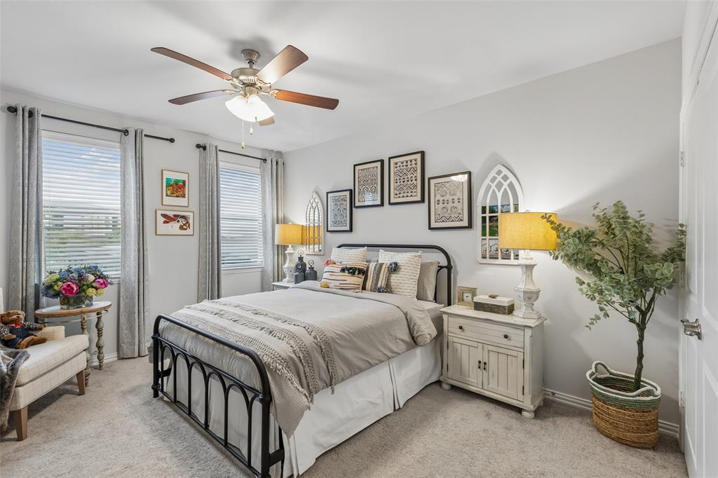 651 Watters Road, Unit 7204 Allen, TX 75013 - Photo 24 of 40 a bedroom with a bed and a potted plant
