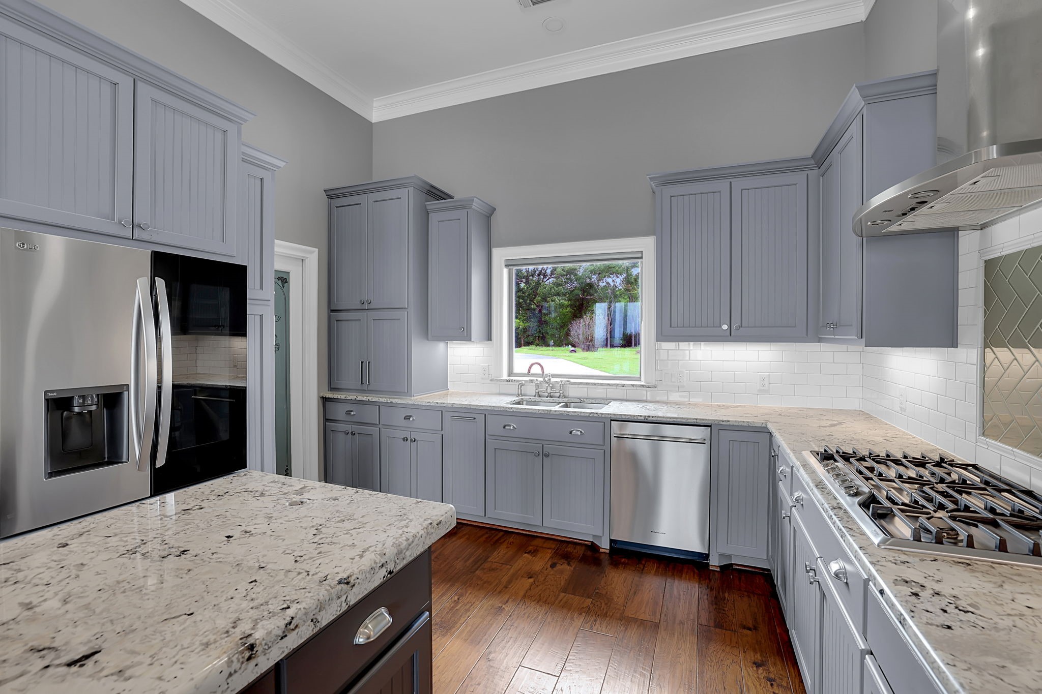 260 Legacy Blvd Point Point Blank, TX 77364 - Photo 12 of 46 Granite countertops and stainless steel appliances, including a gas cooktop