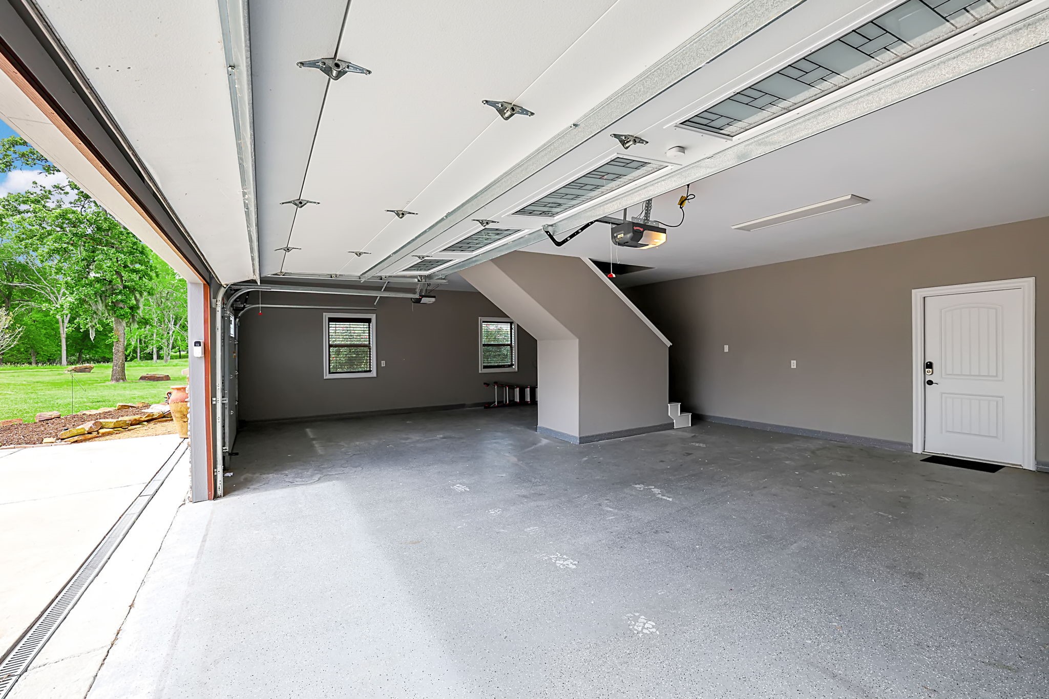 260 Legacy Blvd Point Point Blank, TX 77364 - Photo 41 of 46 The three car garage also has storage space above, easily accessible by stairs
