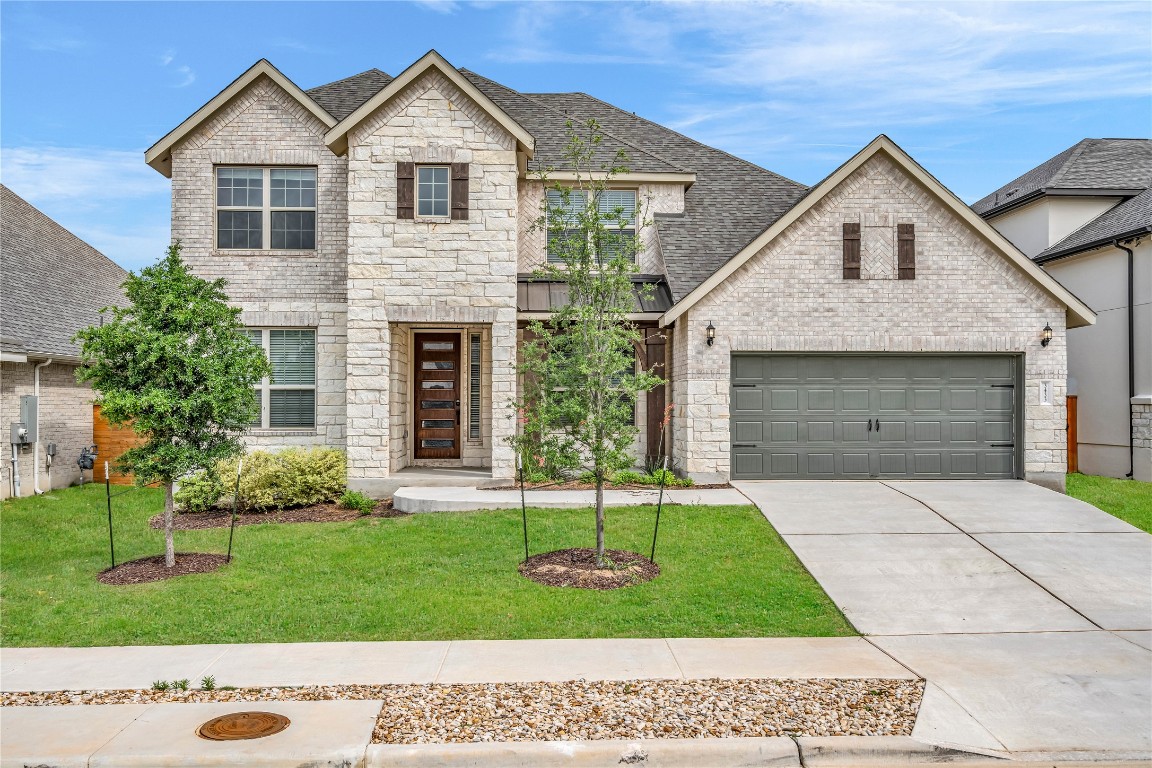 3433 Limousin Drive Leander, TX 78641 - Photo 1 of 1 a front view of a house with a garden and plants