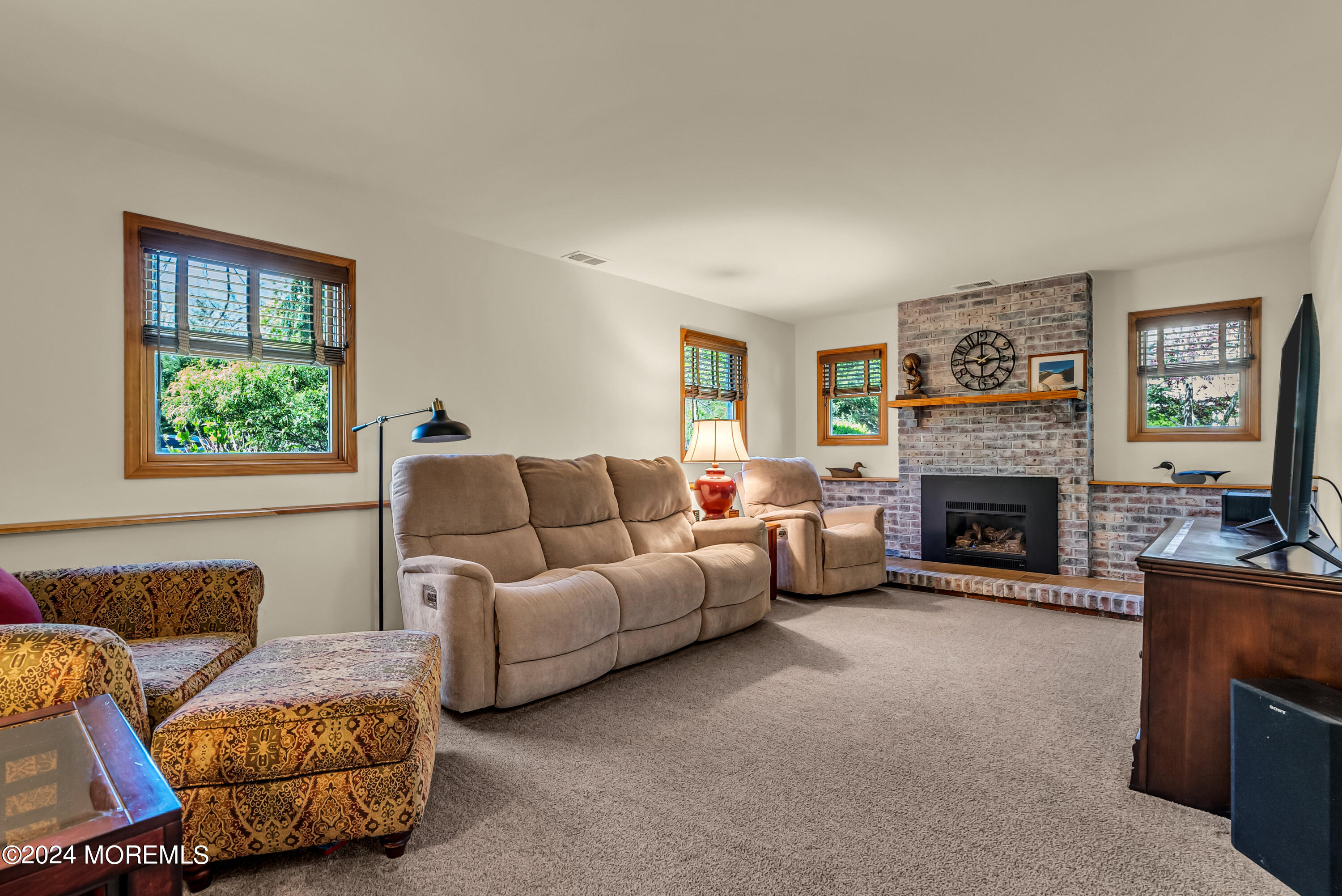 22 Oak Glen Road Toms River, NJ 08753 - Photo 14 of 25 a living room with furniture and a fireplace