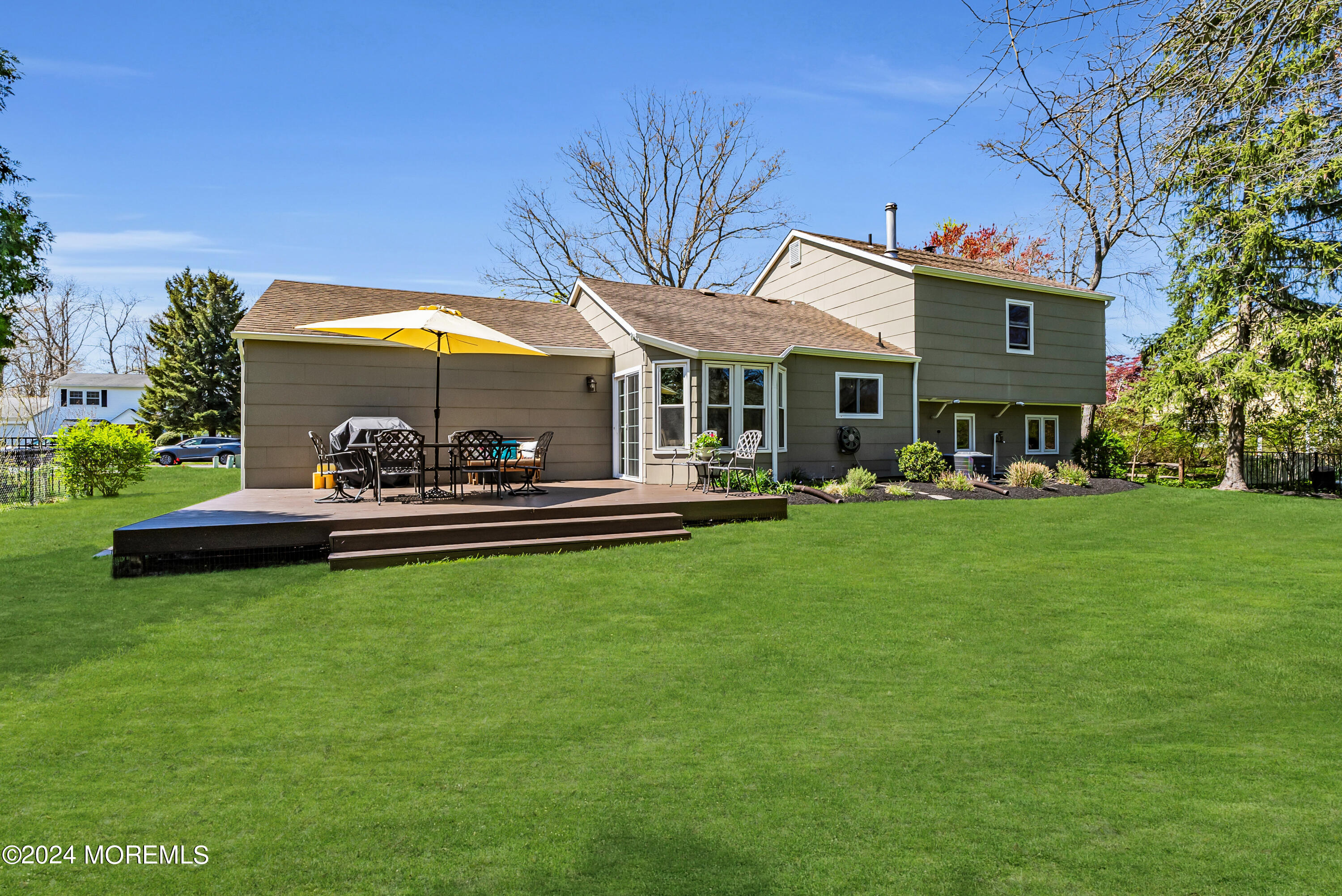 22 Oak Glen Road Toms River, NJ 08753 - Photo 18 of 25 a view of a patio with table and chairs under an umbrella