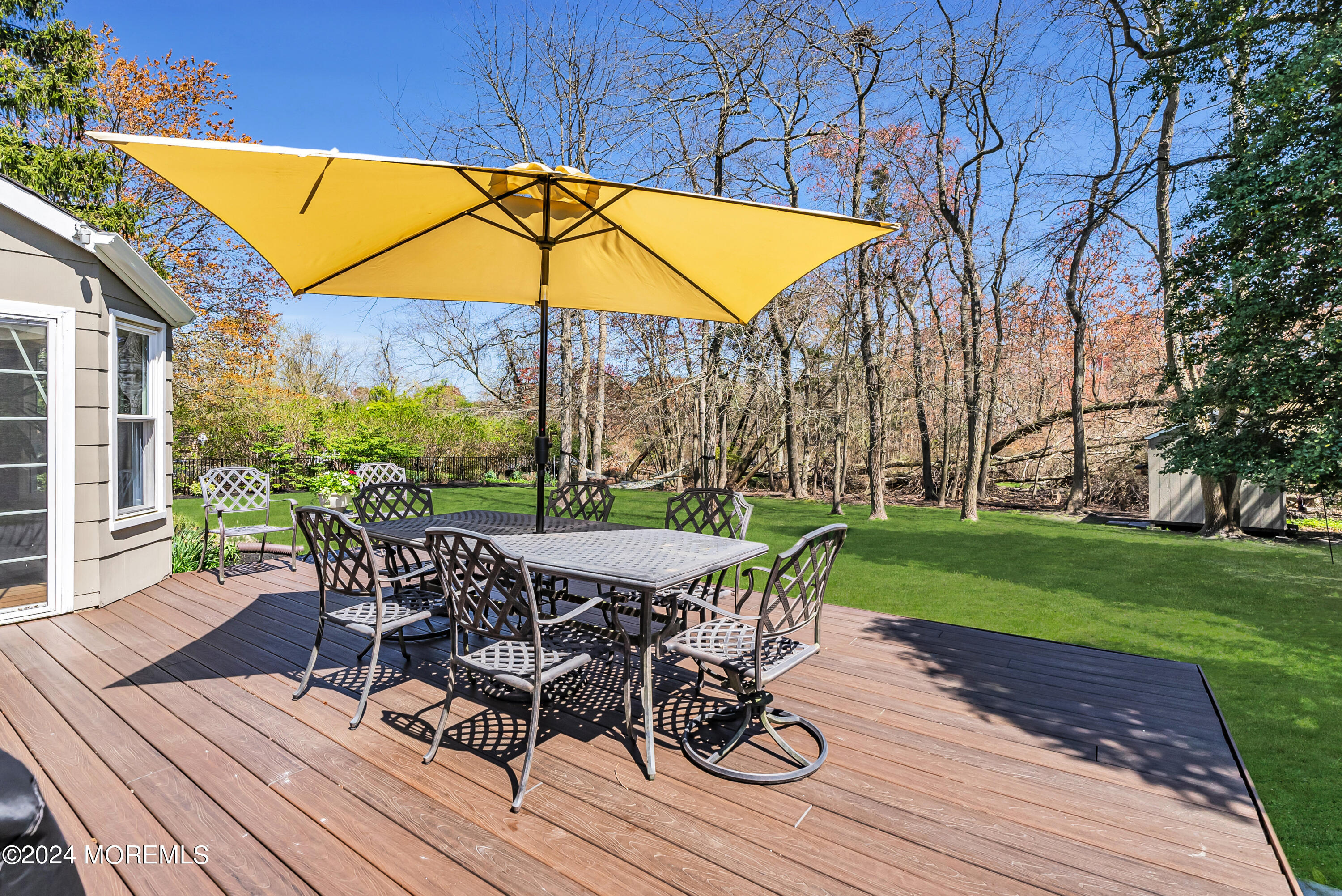 22 Oak Glen Road Toms River, NJ 08753 - Photo 20 of 25 a view of a patio with table and chairs under an umbrella