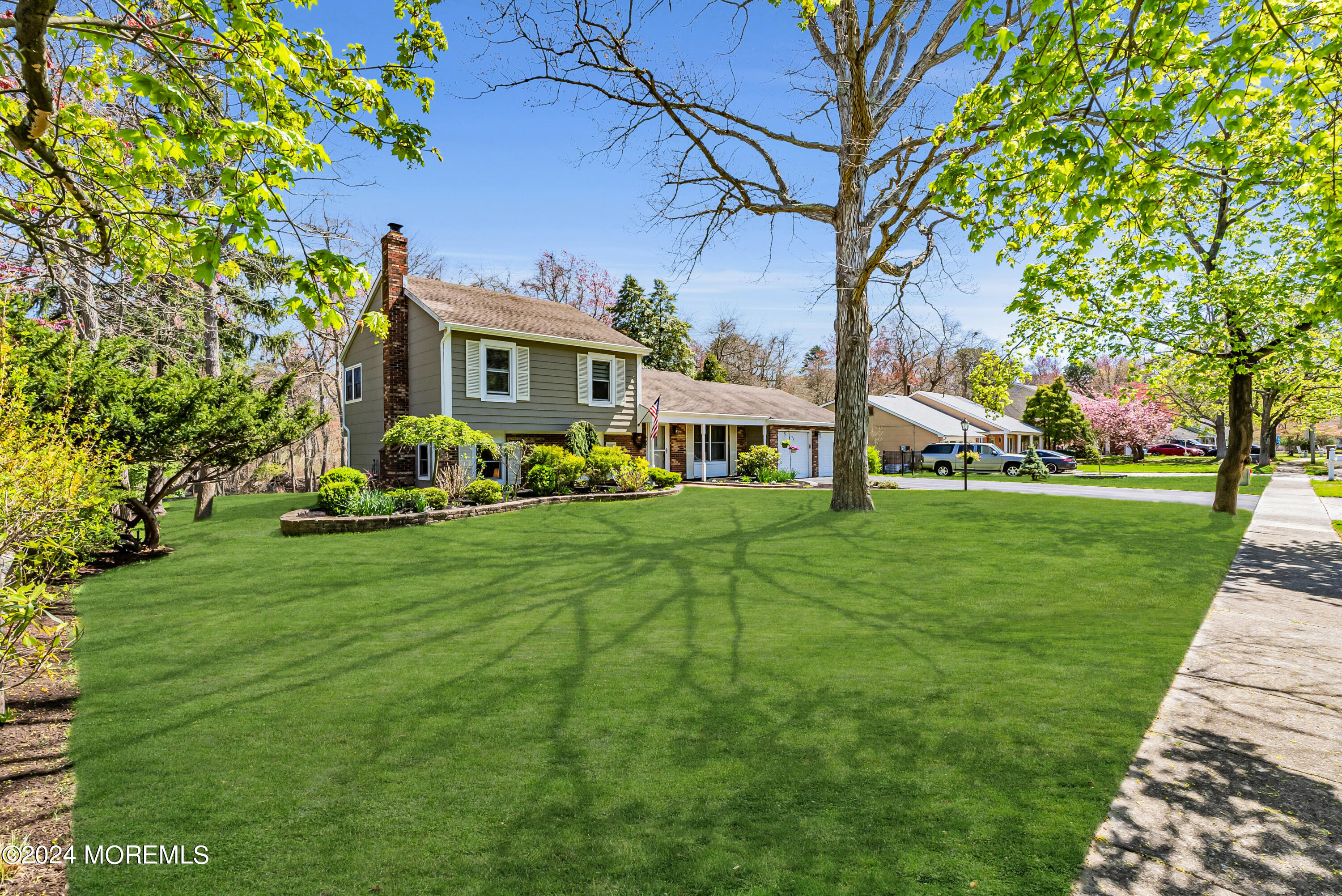 22 Oak Glen Road Toms River, NJ 08753 - Photo 4 of 25 a front view of a house with a yard table and chairs