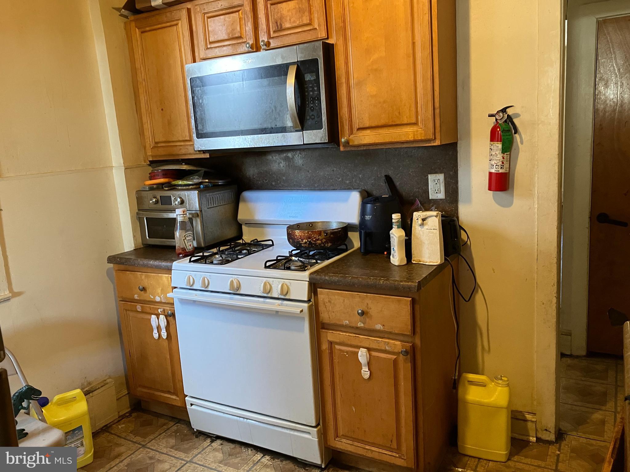 1623 Worrell Street Philadelphia, PA 19124 - Photo 12 of 17 a kitchen with a stove and a microwave