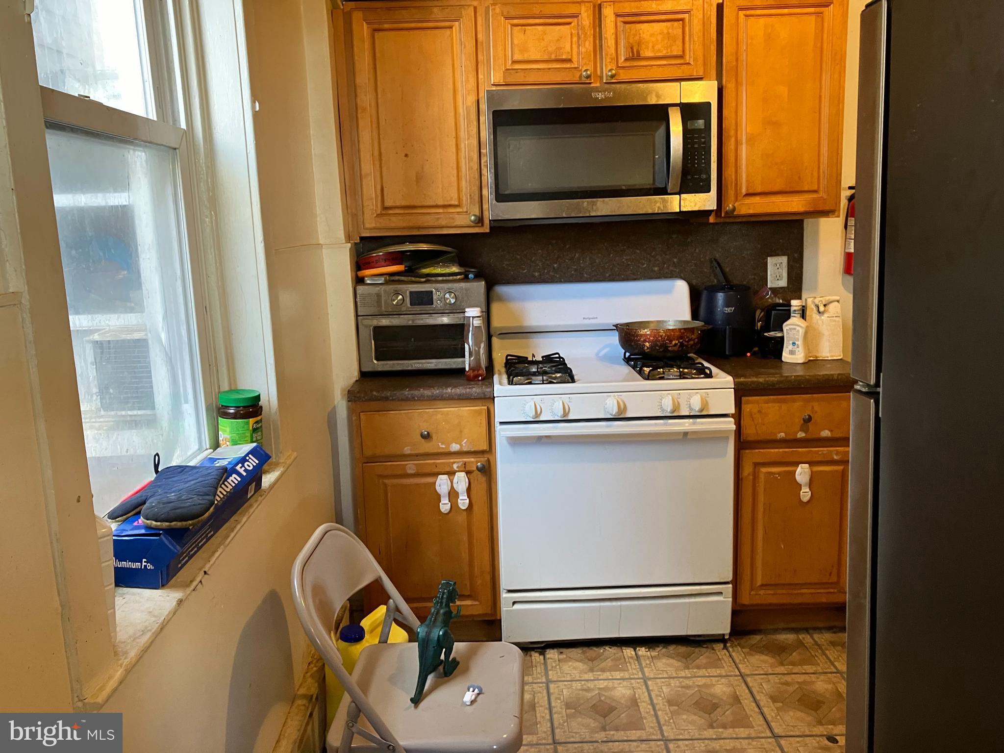 1623 Worrell Street Philadelphia, PA 19124 - Photo 13 of 17 a kitchen with a stove and a microwave