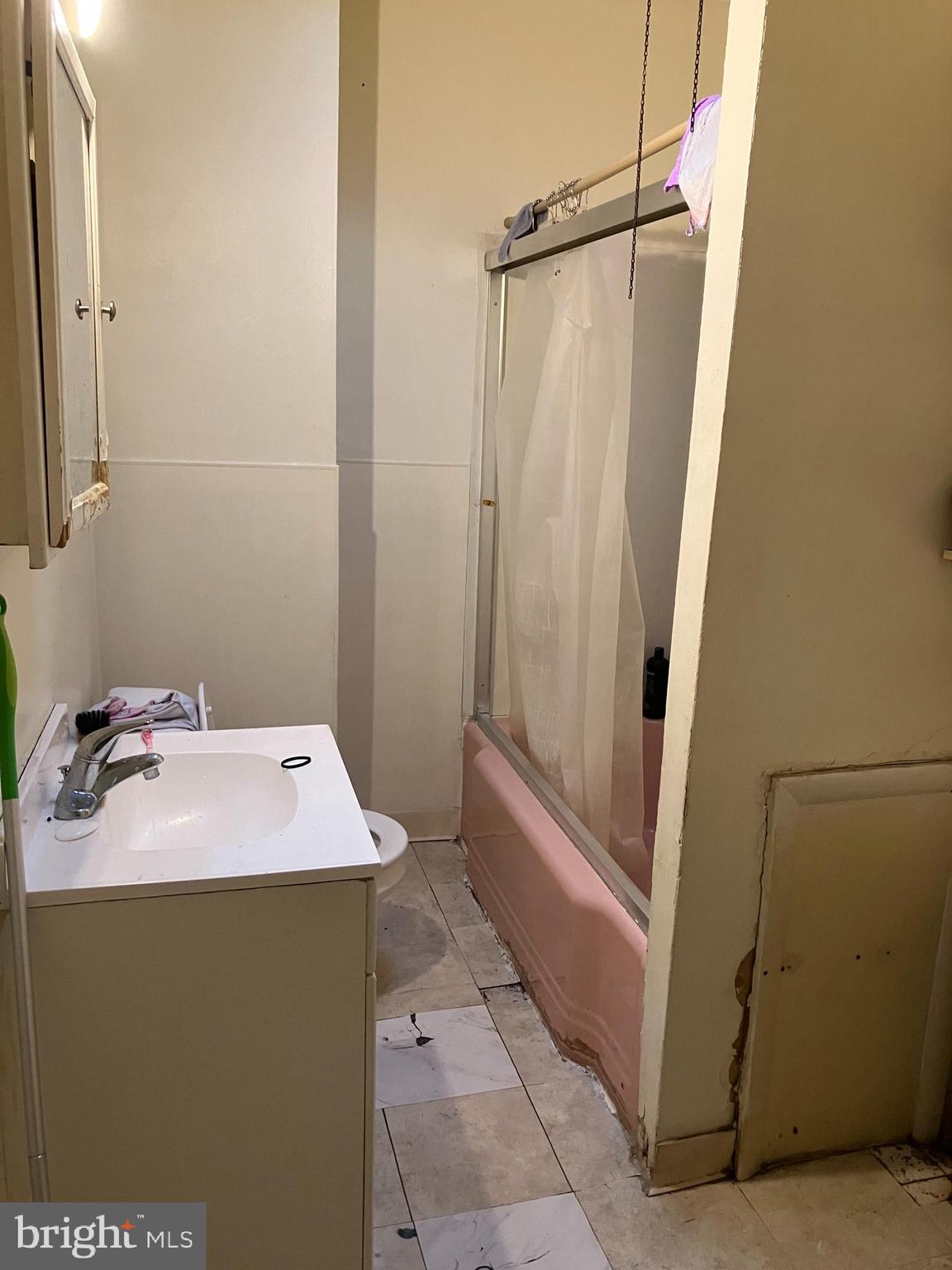 1623 Worrell Street Philadelphia, PA 19124 - Photo 17 of 17 a bathroom with a sink and a mirror