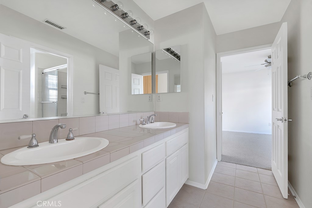 11205 Salerno Porter Ranch Porter Ranch, CA 91326 - Photo 33 of 43 a bathroom with a sink and a mirror