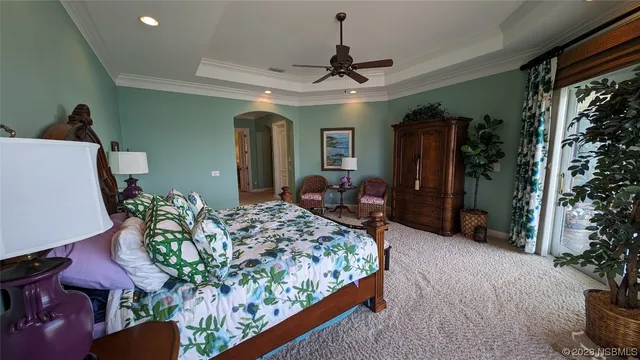 a bedroom with furniture and a ceiling fan