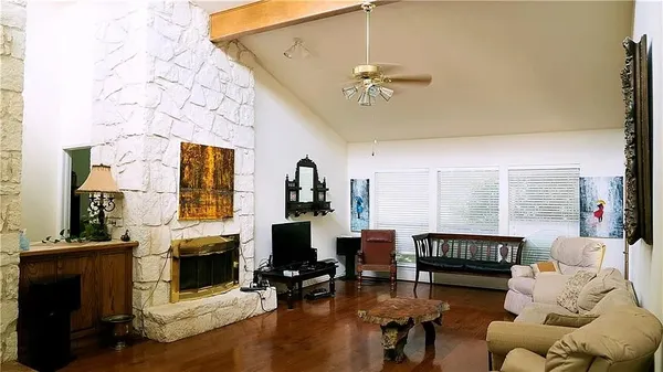 a living room with furniture a fireplace and a flat screen tv