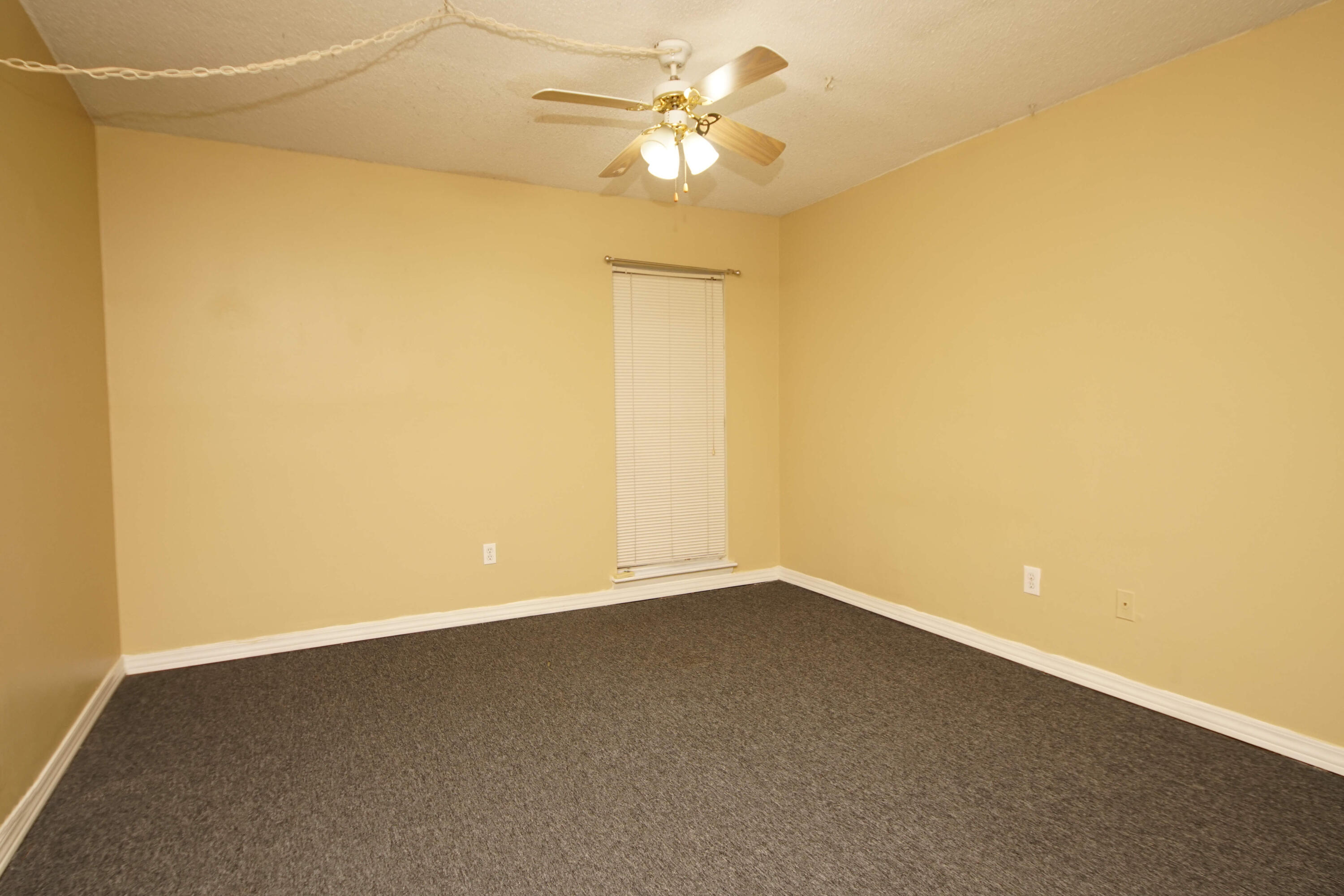 210 Pelham Road, Unit 219C Fort Walton Beach, FL 32547 - Photo 13 of 23 an empty room with a window and a ceiling fan
