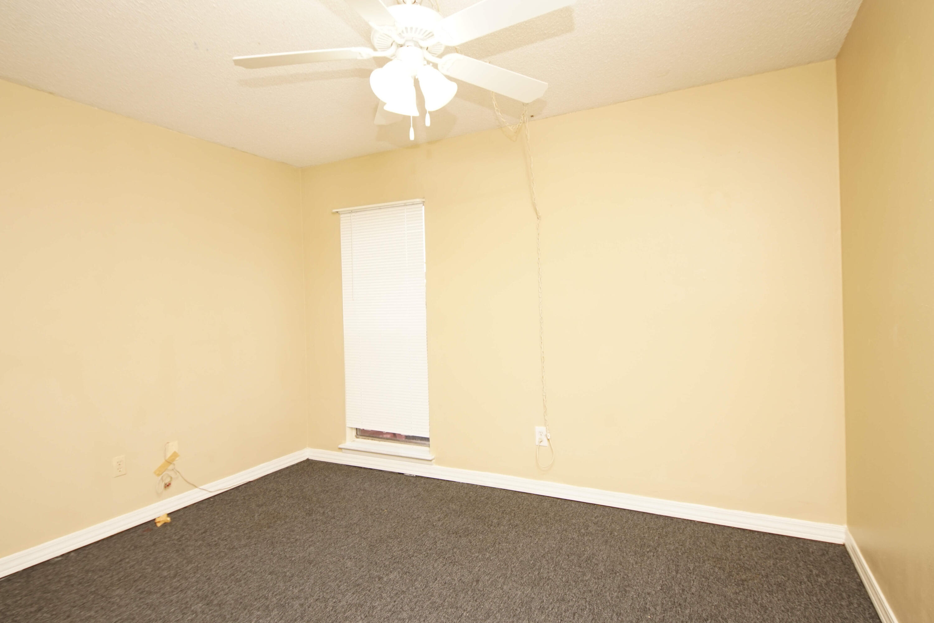210 Pelham Road, Unit 219C Fort Walton Beach, FL 32547 - Photo 16 of 23 an empty room with a ceiling fan and a window