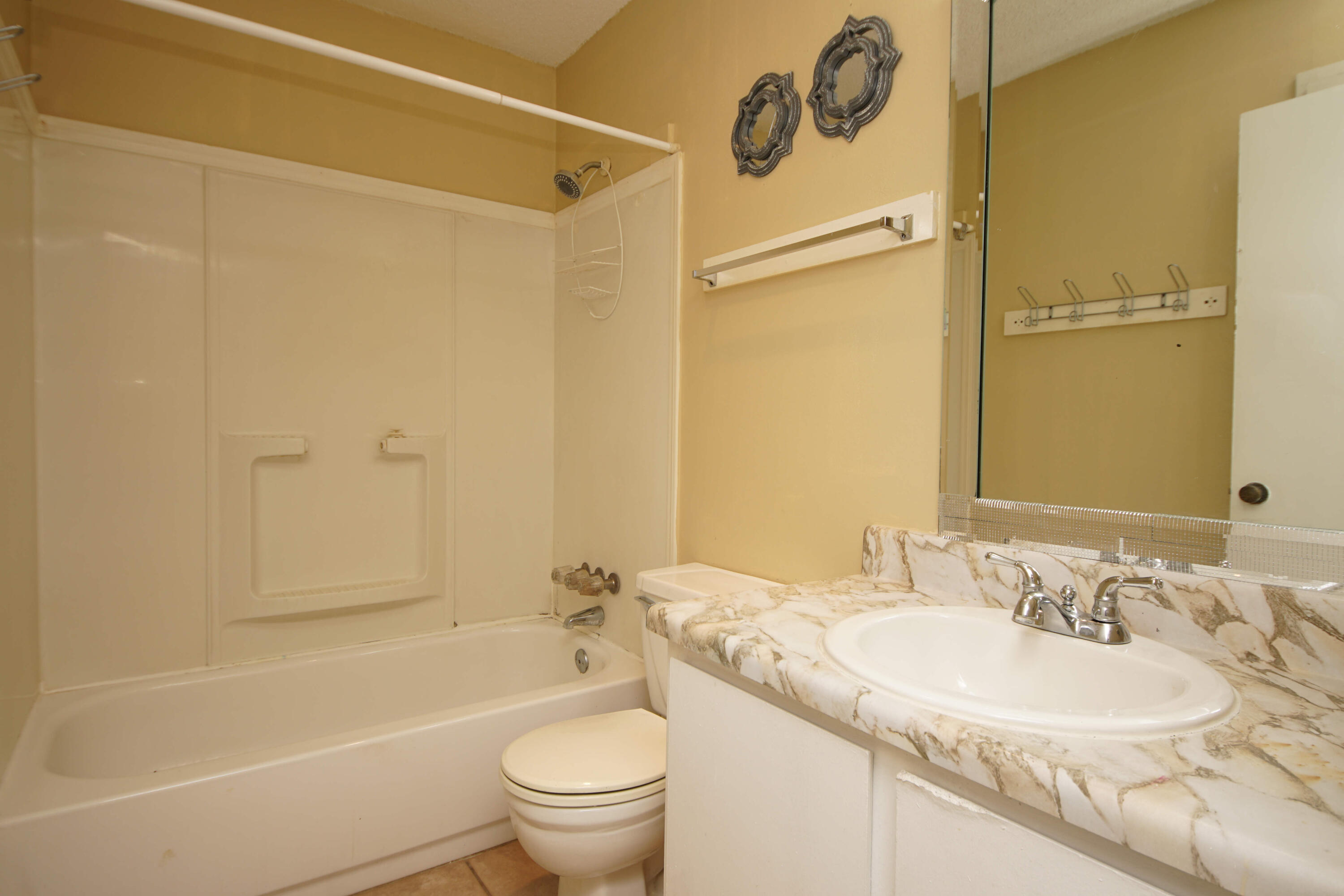 210 Pelham Road, Unit 219C Fort Walton Beach, FL 32547 - Photo 17 of 23 a bathroom with a granite countertop sink toilet and shower