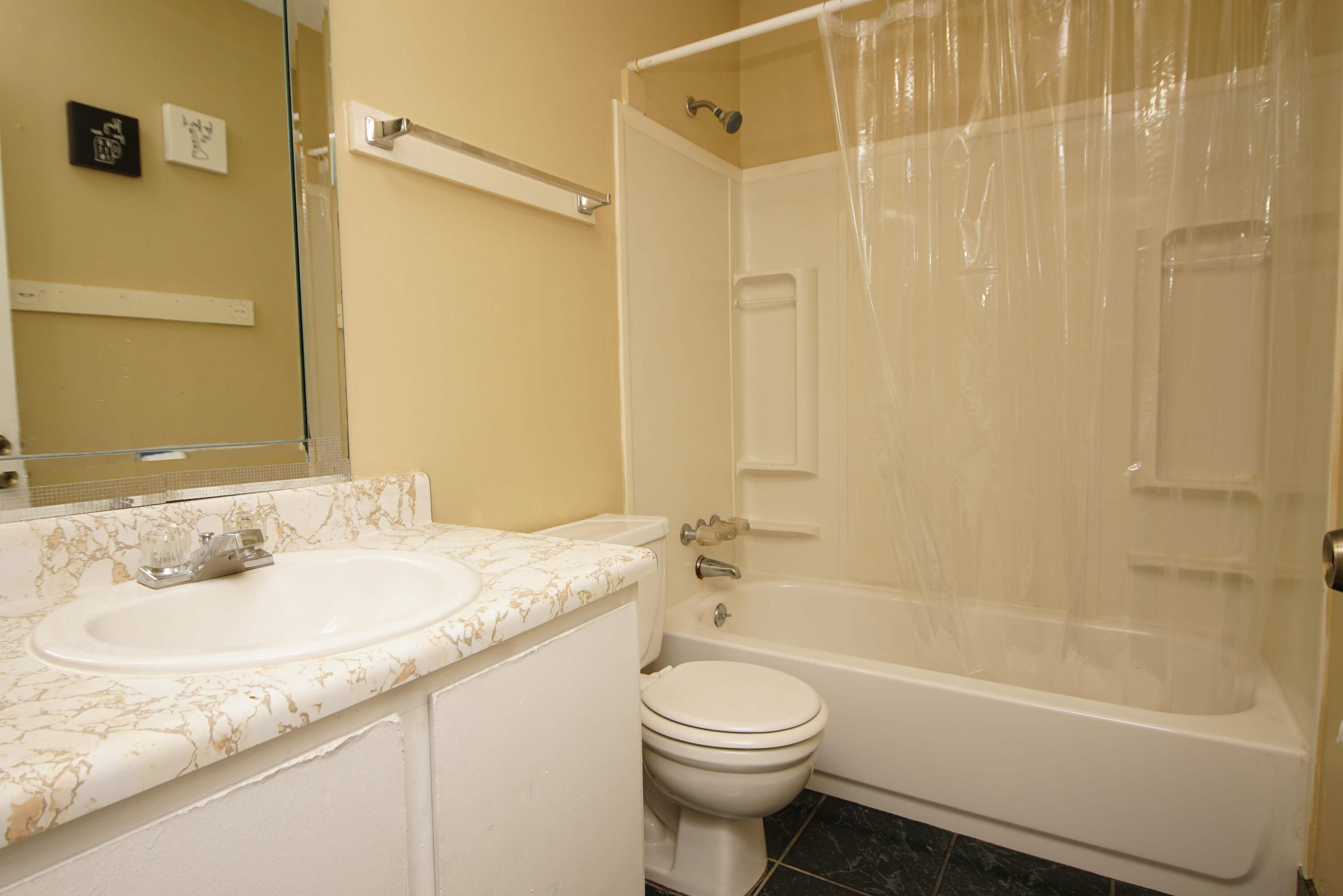 210 Pelham Road, Unit 219C Fort Walton Beach, FL 32547 - Photo 18 of 23 a bathroom with a granite countertop sink toilet and shower