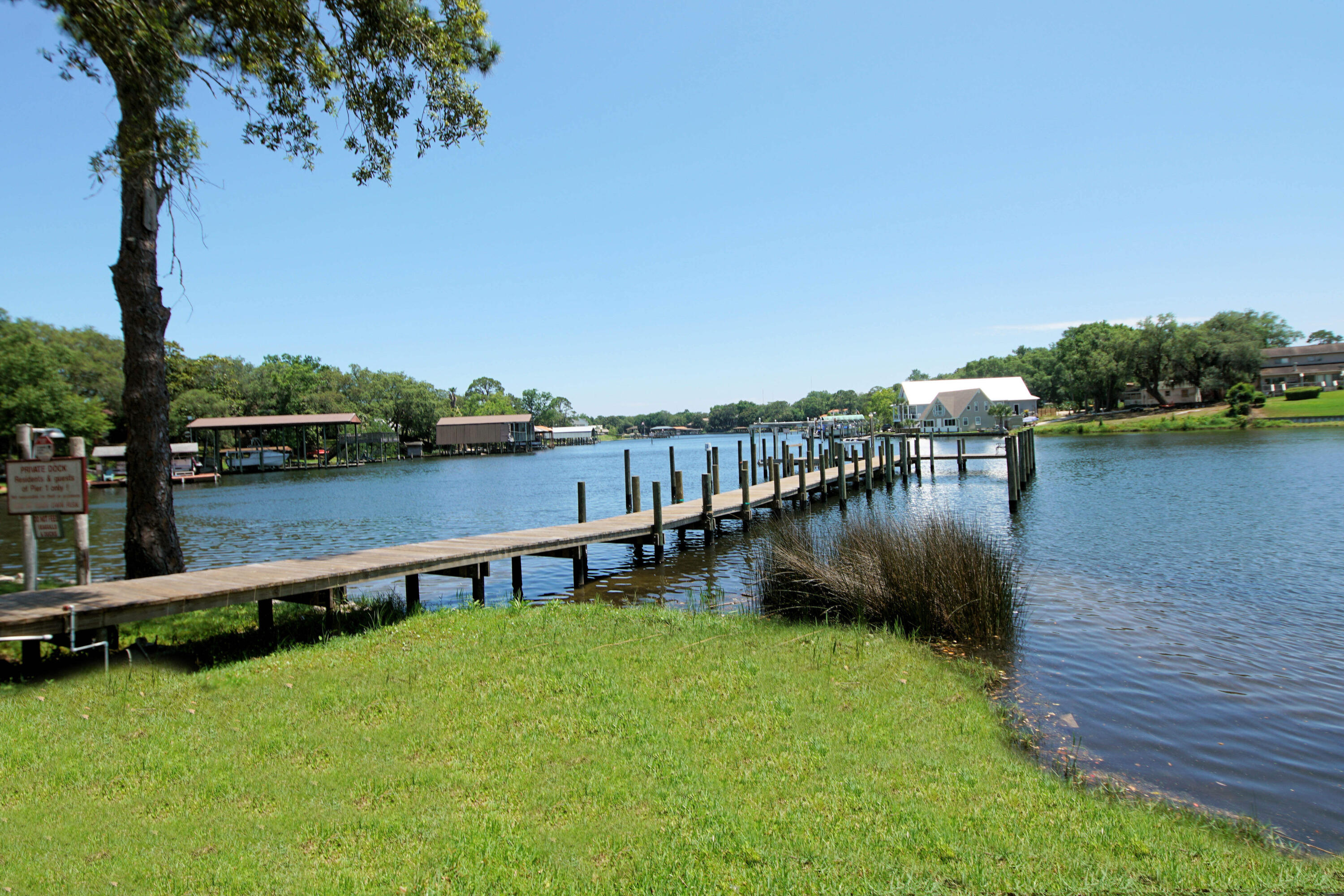 210 Pelham Road, Unit 219C Fort Walton Beach, FL 32547 - Photo 20 of 23 a view of a lake with houses in the back